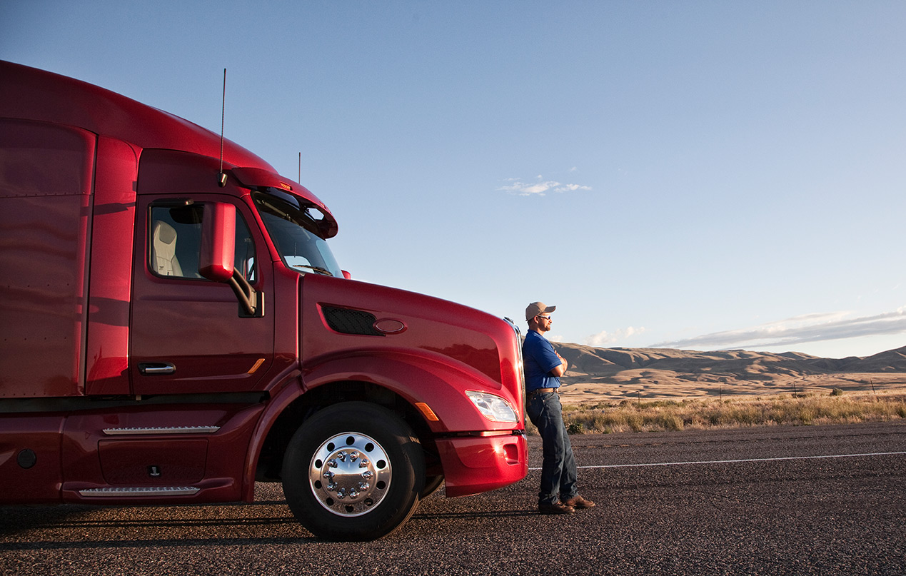 Driver beside a tractor on a Texas highway at dusk
